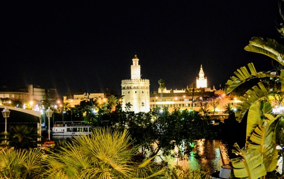 View on river Guadalquivir and Torre de Oro from Triana, Seville at night